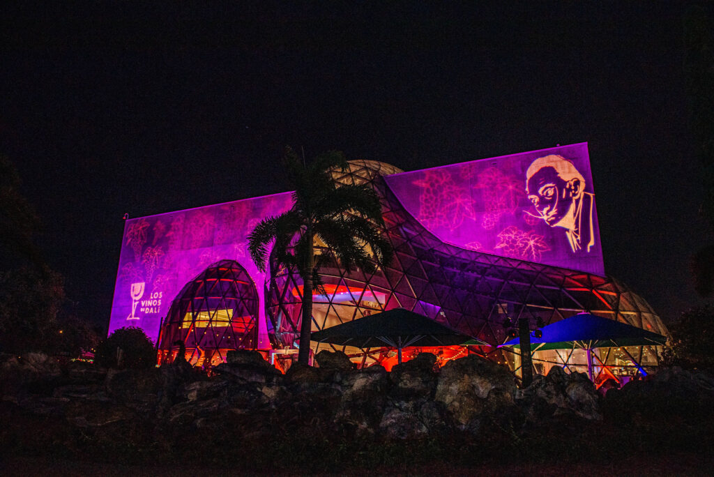 Dalí Museum illuminated with vibrant purple and pink lights for an evening event, highlighting St. Petersburg’s cultural landscape.