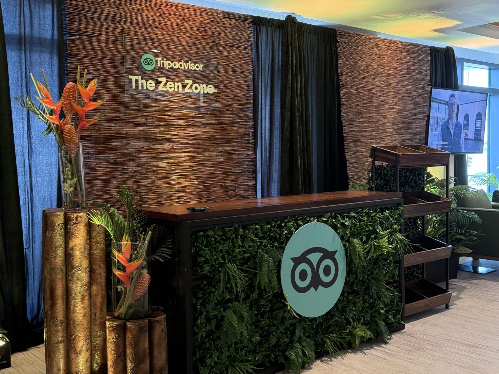 TripAdvisor’s ‘The Zen Zone’ event setup with a bar decorated with green foliage and vibrant floral accents, crafted by UDREAM EVENTS for a tranquil event experience in Florida.