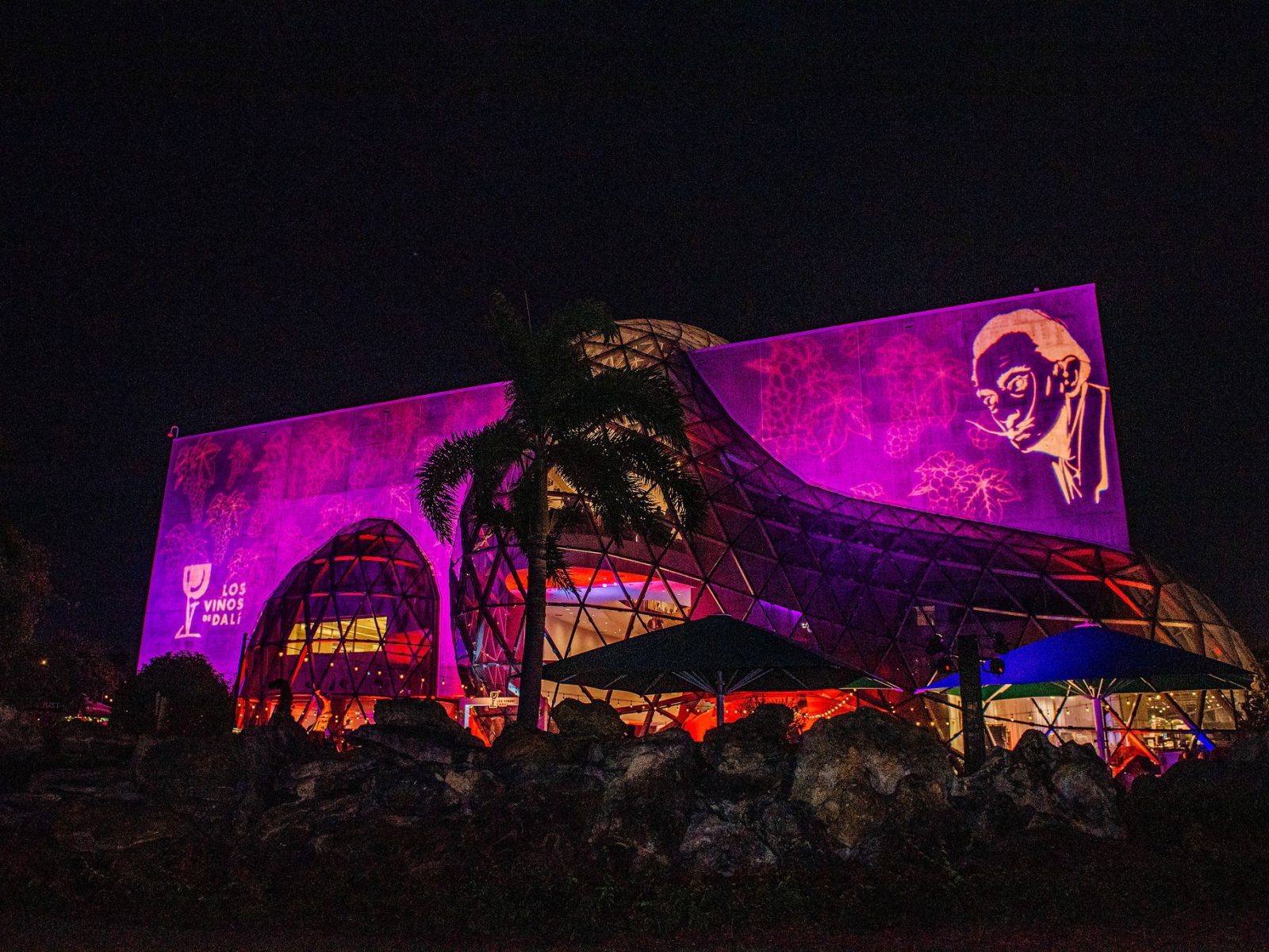 Dalí Museum illuminated with vibrant purple and pink lights for an evening event, highlighting St. Petersburg’s cultural landscape.